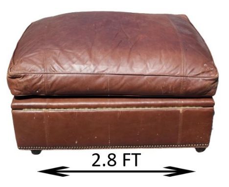 Cushioned leather ottoman with nailhead trim, storage compartment. Measurements: 34 x 27 1/2 x 18 in. Please note that all sa