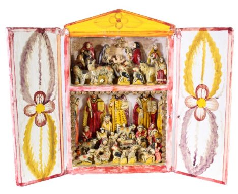 Two-tiered Peruvian retablita made of wood and clay, brightly painted and charmingly rendered. Bottom tier features a nativit