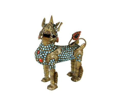 Lightweight brass Foo Dog/Lion with coral and turquoise insets. Possibly Tibetan or Nepalese, early 20th century. Size: 7 1/2