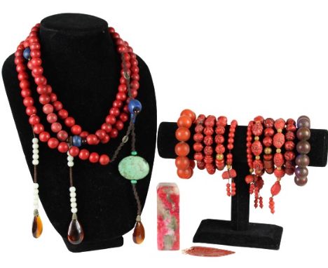 Collection of red beaded jewelry including 1 long necklace with several dangling pendants, 11 bracelets, 1 pendant, and 1 sto