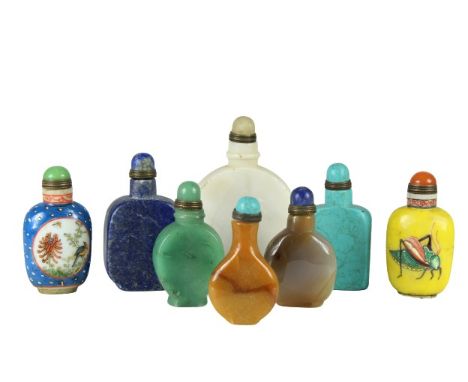 Beautiful stone snuff bottles, all have different colors and vary in sizes and each has a colorful top. Two of the undersides