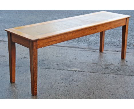An oak office writing table inset brown leather to the narrow rectangular top, &amp; on four square tapered legs, 202cm long 