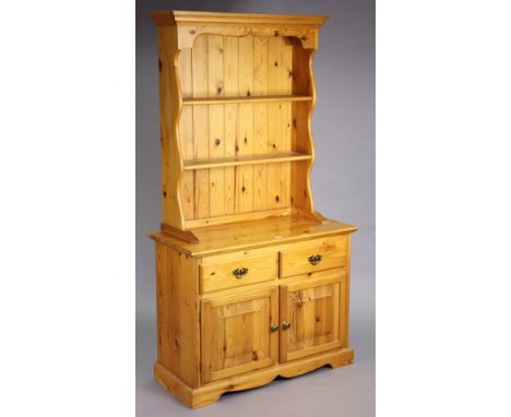 A pine small dresser, the upper part with two open shelves &amp; having a panelled base, the base fitted two frieze drawers a