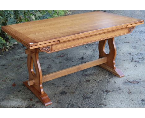 An oak draw-leaf dining table on pierced &amp; shaped end supports joined by a plain centre stretcher; &amp; a ditto set of s