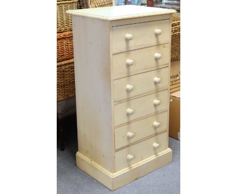 A cream painted pine small upright chest fitted six long drawers with turned knob handles, &amp; on a plinth base, 53.5cm wid