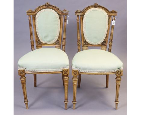 A pair of 19th century carved beech frame occasional chairs with padded seats &amp; backs, &amp; on turned &amp; fluted taper