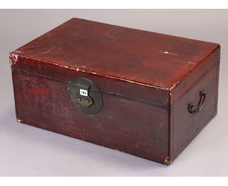 A Chinese red lacquered travelling case having a hinged lift-lid, &amp; with a bronzed lock plate &amp; side handle (slight f