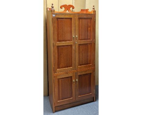A mahogany tall tray-top cupboard enclosed by two pairs of fielded panel doors, 77cm wide x 177cm high x 41.25cm deep. 