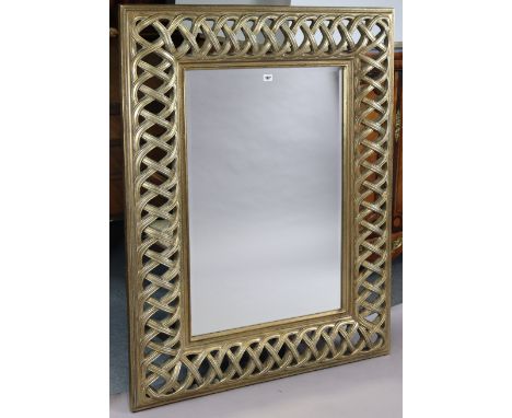 A large silvered-frame&nbsp;rectangular wall mirror with a pierced border &amp; inset with a bevelled plate, 130cm x 99.5cm.