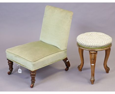 A Victorian nursing chair with a padded seat &amp; back upholstered pale green velour, &amp; on short turned legs with cerami