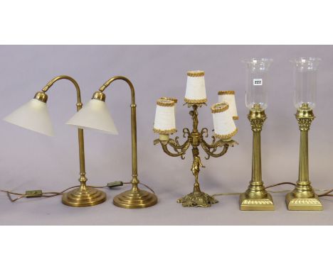 A pair of brass Corinthian-style table lamp bases each with a glass shade; another pair of brass table lamp bases; &amp; a br