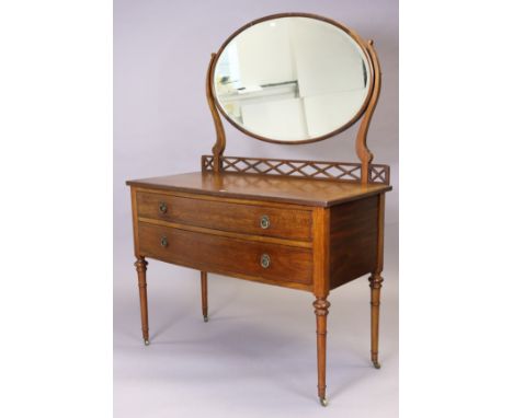 An Edwardian inlaid-mahogany bow-front dressing table with an oval swing mirror to the stage back fitted two long graduated d