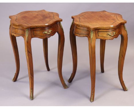 A pair of continental-style mahogany circular occasional tables each fitted with a frieze drawer, having gilt ormolu mounts, 