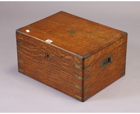 An oak &amp; brass-mounted canteen fitted four removable trays enclosed by a hinged lift-lid, bears plaque “Army &amp; Navy C