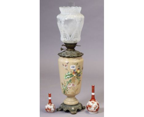 A Victorian peach glass oil table lamp with painted bird &amp; floral decoration on a metal base, &amp; with a moulded &amp; 