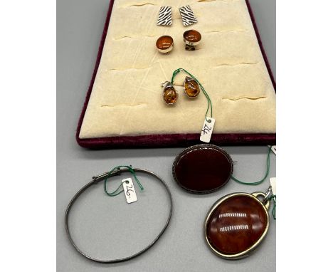 Silver jewellery items; Three pairs of silver earrings- two pairs fitted with amber, Silver and red agate brooch and silver b