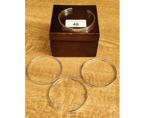 Four various silver bangles; 2000 millennium London silver bangle and three various other silver bangles. 