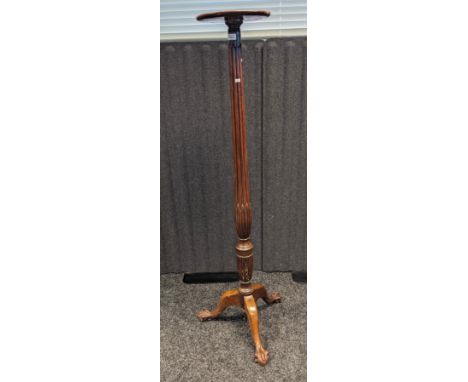 19th century mahogany torcher, the circular top above a carved column, raised on a tripod base ending in claw and ball feet [