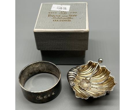 Two silver items; Birmingham silver shell design salt with matching spoon, Britannia silver napkin ring with box. 