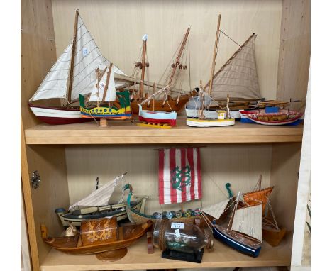 Two shelves of boat models; ship in bottle, Musical gondola boat model, Viking Long boat model and various others 