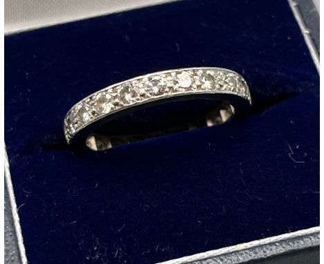 High grade white gold or platinum band ring set with approximately 1.1ct diamonds. [Ring size N] [4.44Grams] 