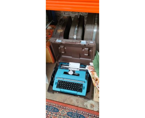 Four various travel cases and portable typewriter 