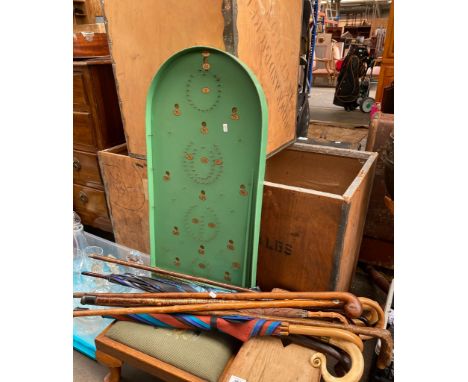 Vintage bagatelle game together with various walking sticks and umbrellas 