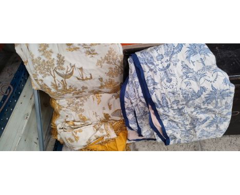 A Lot of ornate double lined curtains. 