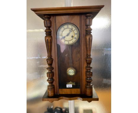 Antique wall clock with key and pendulum. in a working condition. 