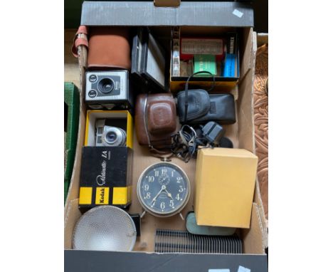 Box of cameras and equipment; Kodak, cameras, Ingersoll Revally Radiolite Alarm clock and various odds. 