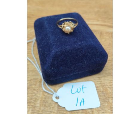14ct yellow gold ladies ring set with a single pearl sat upon a rose flower setting. [Ring size P] [2.66Grams] 