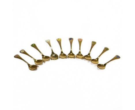 A collection of nine Georg Jensen gilded and enamel Year Spoons, stamped marks, for the years 1975, 1976, 1981, 1982, 1987, 1