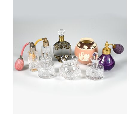 Three glass atomisers, two clear and one purple, a frosted glass metal mounted perfume bottle, a pair of clear cut-glass pots