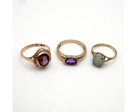 A 9 carat gold single stone opal ring; with two 9 carat gold amethyst dress rings, 7 grams gross.