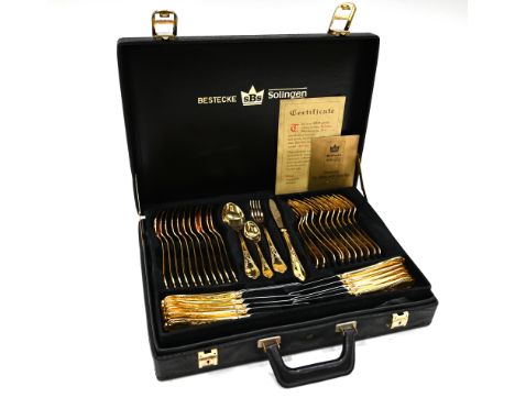 A "Bestecke" gold plated canteen of cutlery by SBS of Solingen, comprising a 12 place setting, in two layers, of knife, fork,