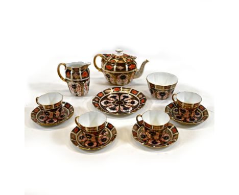 A part tea set by Royal Crown Derby comprising teapot, milk jug, sugar bowl, sandwich plate, four cups and six saucers, all i