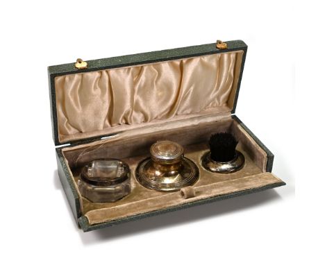 A boxed silver desk set comprising: a silver and glass stamp moistener hallmarked I.M Hutchfield 1920 107g gross, approx 3cm 