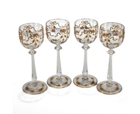 A set of four Moser hock glasses with air twist stems, decorative Puginesque knops and gilt floral swags and scales enamel pa