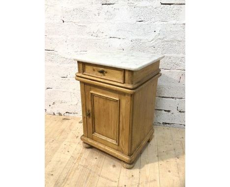 A Victorian bedside cabinet with marble top over single frieze drawer and panelled cupboard space with single shelf to interi