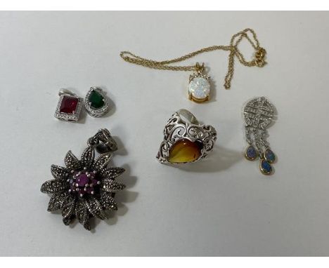 A silver ring with polished pear shaped amber to centre, size P, a silver pendant with purple stones to centre, and four othe