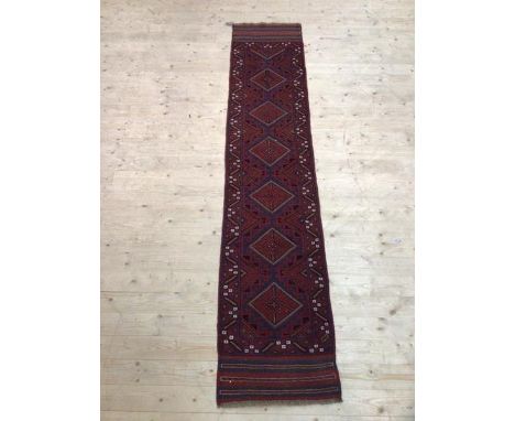 A Mashwani runner with six diamonds to field within geometric border and overall motif, (275cm x 60cm)