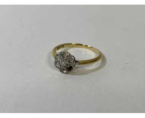 A gold cluster ring marked 18k, with five diamonds, one other stone and one stone missing, size N, weighs 2 grammes