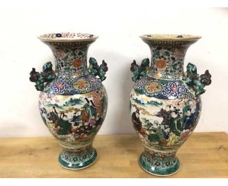 A pair of 20thc Chinese vases of baluster form in famille vert pattern, with lion handles, seal marks to base (31cm h)