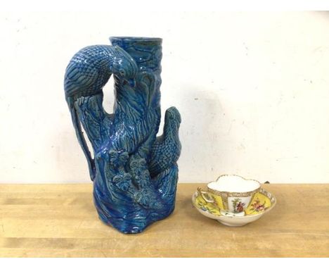 A vase in the form of a tree trunk with two birds having blue glaze, (25cm h) and a French teacup and saucer of small proport