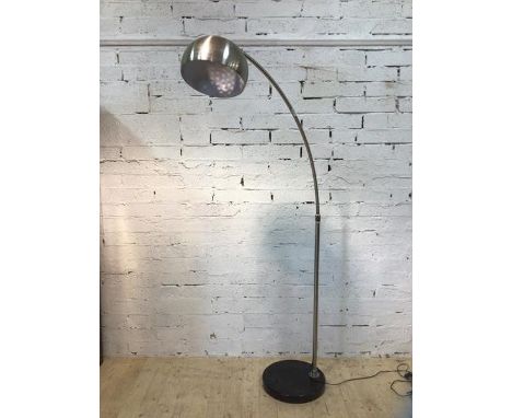 An arched standard lamp the polished dome shade with perforated top on circular marble base, (220cm h)