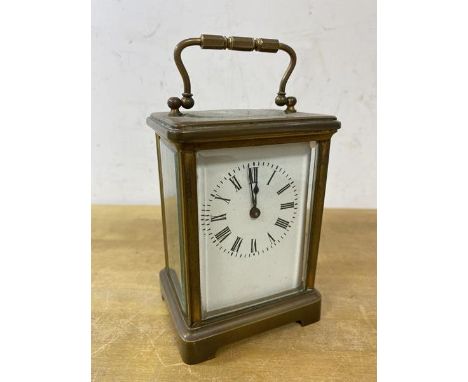 A brass and four glass carriage clock, roman numerals, (14cm h including handle)