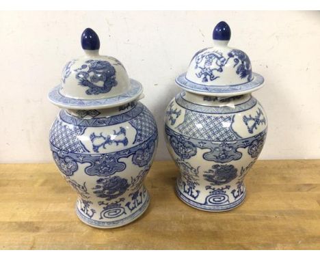 A pair of blue and white Chinese lidded baluster shapes vases, (26cm h), blue seal marks to base