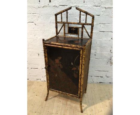 A cane and lacquered panel side cabinet the architectural super structure with lacquered and gilt decorated panel above top a