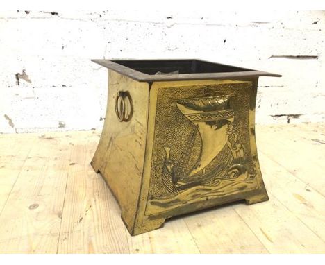 A brass effect log bin with Viking long ship to front and back and drop ring handles to sides, (27cm x 30cm x 30cm)