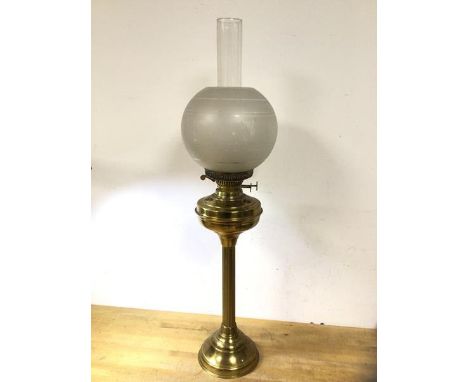 An early 20thc brass gas lamp with frosted shade on column stem base, (76cm h including glass)